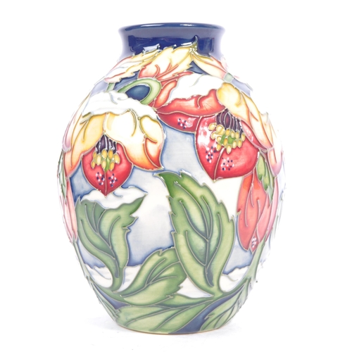 79 - Moorcroft Pottery - A contemporary 21st century ceramic hand painted Moorcroft vase. A 'Christmas He... 