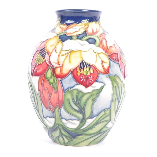 79 - Moorcroft Pottery - A contemporary 21st century ceramic hand painted Moorcroft vase. A 'Christmas He... 