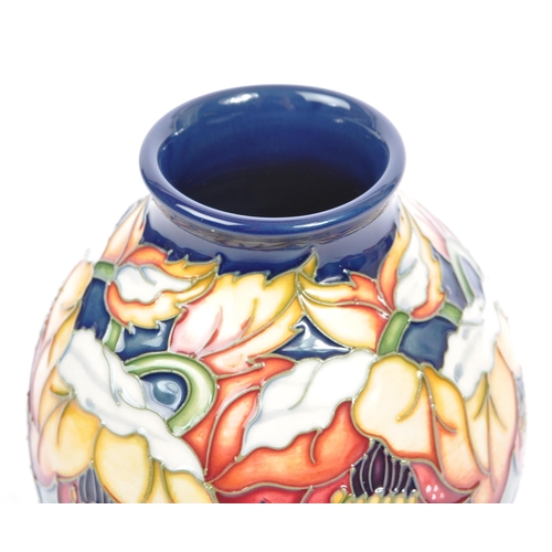 79 - Moorcroft Pottery - A contemporary 21st century ceramic hand painted Moorcroft vase. A 'Christmas He... 