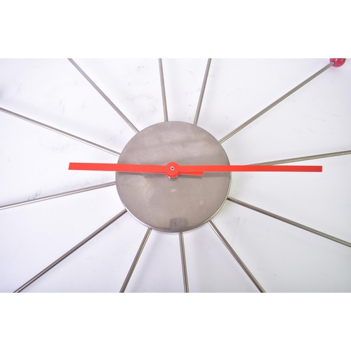 184 - A vintage mid 20th century Sputnik atomic style wall clock. The clock with sunburst tubular metal ra... 