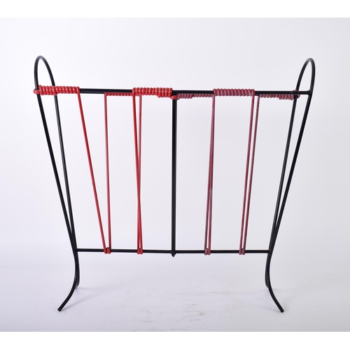 185 - A mid 20th century vintage sputnik atomic ebonised wire magazine rack. The rack having wrapped plast... 