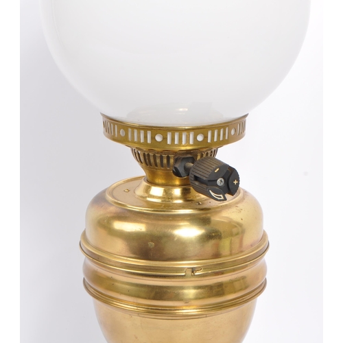 338 - A 20th century brass oil lamp. The oil lamp having brass reservoir and base and being accompanied by... 