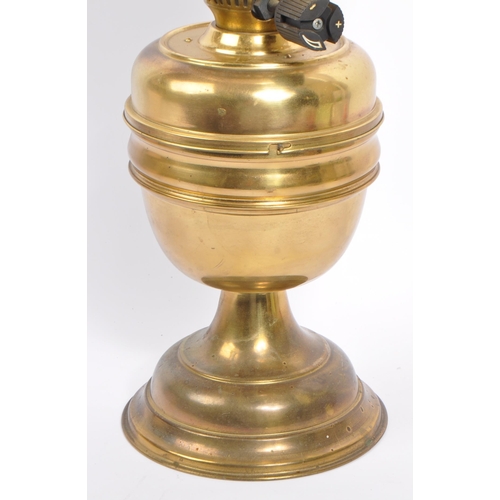 338 - A 20th century brass oil lamp. The oil lamp having brass reservoir and base and being accompanied by... 