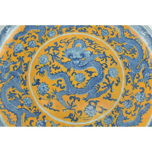 100 - A Chinese Oriental early 20th century blue & white ceramic Kangxi five claws charger plate. The char... 