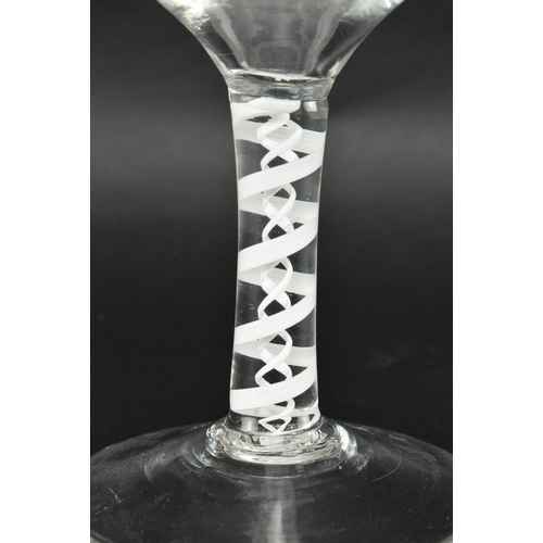 110 - A circa 1765 George III opaque twist wine goblet. The goblet with ogee bowl on double opaque twist s... 