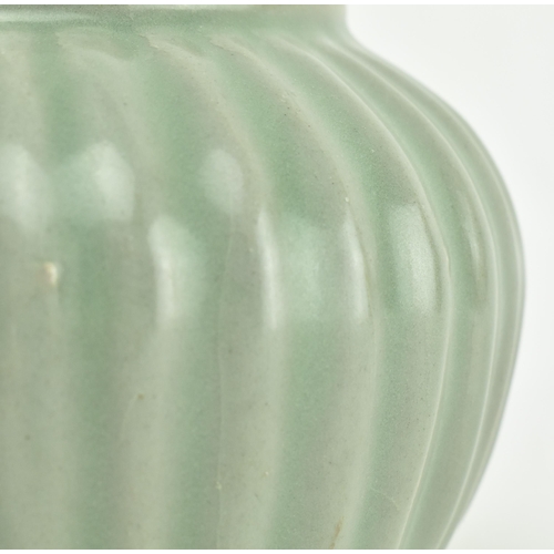 127 - An early 19th century Qing dynasty Longquan celadon ribbed jar. The jar moulded with vertical ribs e... 