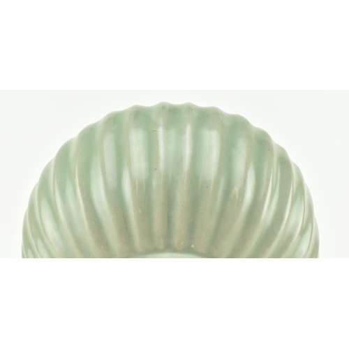 127 - An early 19th century Qing dynasty Longquan celadon ribbed jar. The jar moulded with vertical ribs e... 