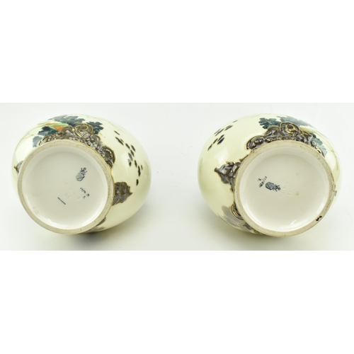 136 - A pair of Austrian late 19th century Ernst Wahliss of Vienna hand painted porcelain twin handled vas... 