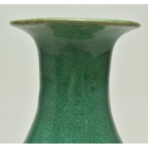 14 - A Chinese late Qing Dynasty early 19th century green glazed ceramic footed vase. The vase of baluste... 