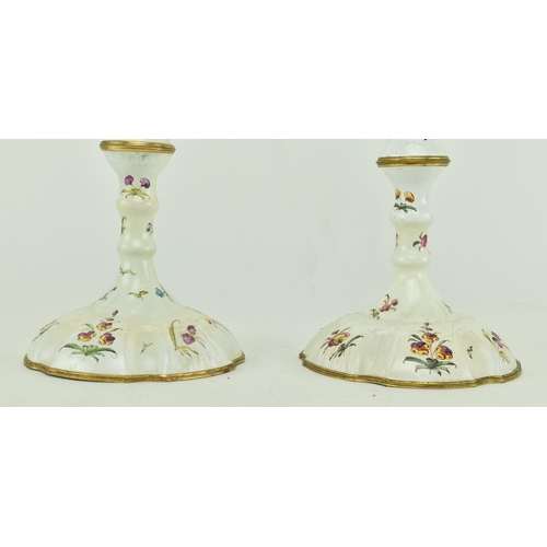 157 - A pair of mid 18th century c1765 Bilston enamel candlesticks, along with one other. The pair with pe... 