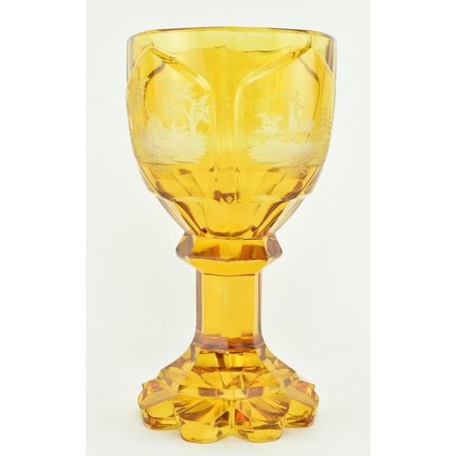 168 - Bohemian Glass - A late 19th century amber cut glass pedestal goblet cup. The goblet with a faceted ... 