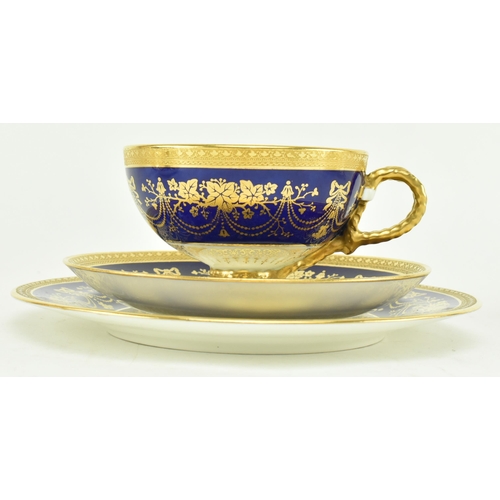 17 - Brown Westhead & Moore - Cauldon - A set of four trio sets of gilt and cobalt blue tea cups and sauc... 