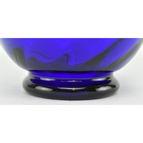 172 - An early-mid 19th century cobalt blue glass water jug. The jug with trailed design around the flared... 