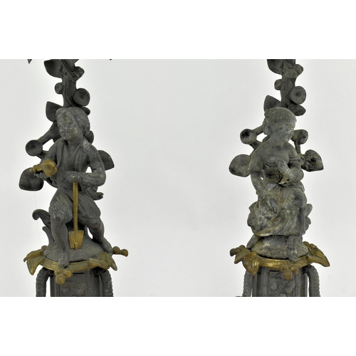 173 - A pair of early 20th century spelter & bronze figurative mantel candlesticks. Each candlestick havin... 