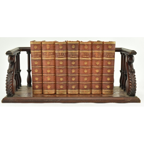 177 - A 19th century inspired carved mahogany desk book trough with a late Victorian collection of writers... 