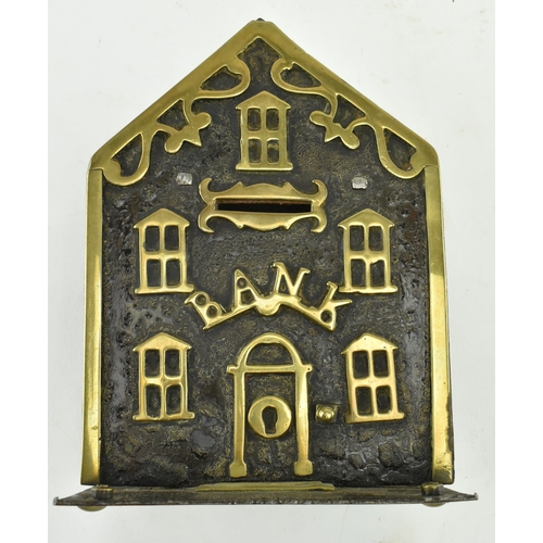 197 - A Victorian 19th century cast iron & brass house shaped money box bank. The money box having a house... 