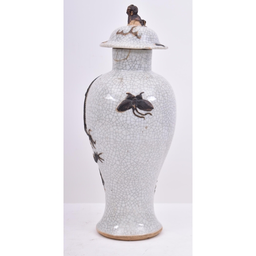 207 - A 19th century Chinese crackle glaze vase featuring two five clawed dragons. The vase with a lid fea... 