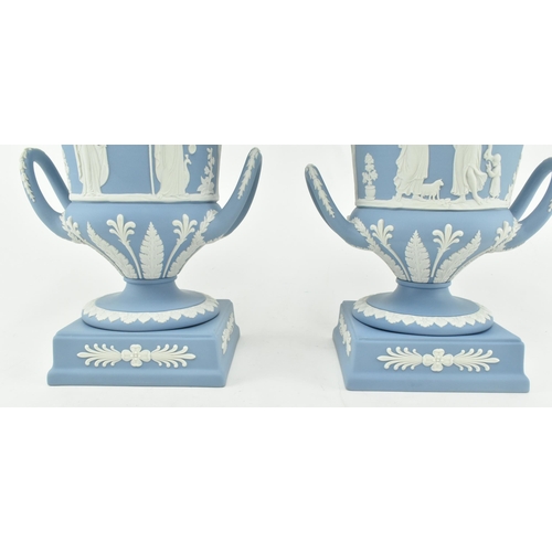 208 - A pair of Wedgwood jasperware ceramic light blue twin handled campagna urns vases with lids. Each va... 