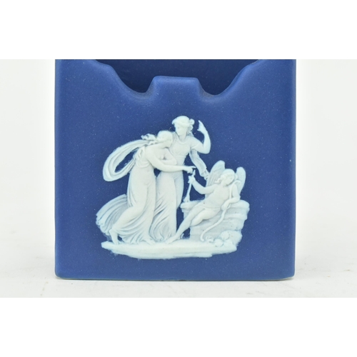 212 - A Wedgwood dark blue jasperware rectangular wall pocket, decorated with three classical maidens, the... 