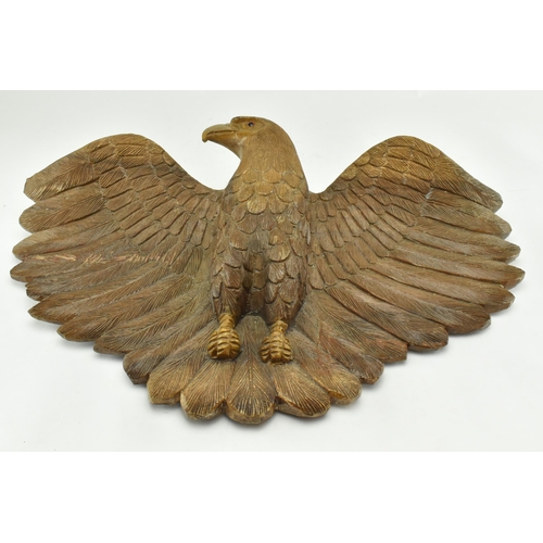 218 - An early 20th century circa 1930s carved wood wall hanging eagle sculpture. The figure depicting a s... 