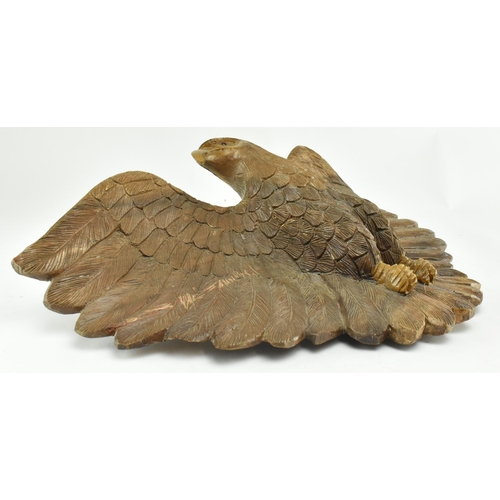 218 - An early 20th century circa 1930s carved wood wall hanging eagle sculpture. The figure depicting a s... 