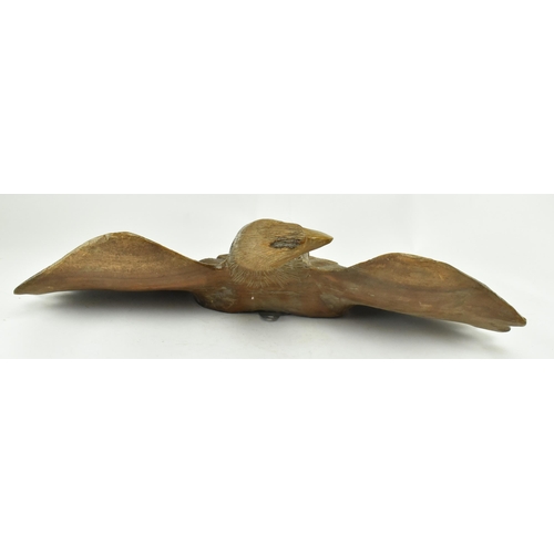 218 - An early 20th century circa 1930s carved wood wall hanging eagle sculpture. The figure depicting a s... 