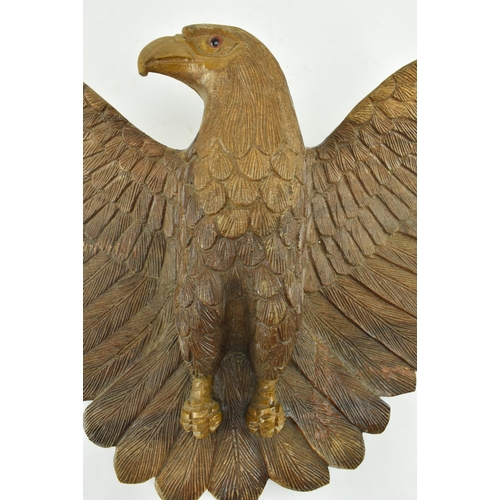 218 - An early 20th century circa 1930s carved wood wall hanging eagle sculpture. The figure depicting a s... 