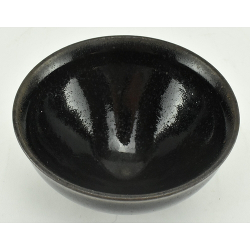 219 - A late Song Jian ware tea bowl. The deep conical bowl with a slightly everted rim, covered in thick,... 