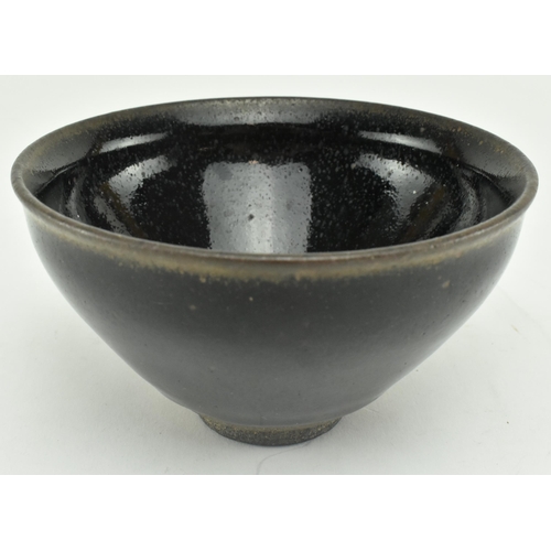 219 - A late Song Jian ware tea bowl. The deep conical bowl with a slightly everted rim, covered in thick,... 