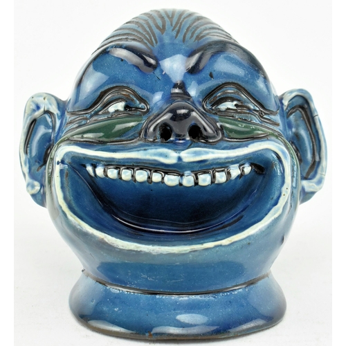 231 - A Grotesque Dartmouth Pottery inspired ceramic match striker / ashtray. The match striker in the sha... 