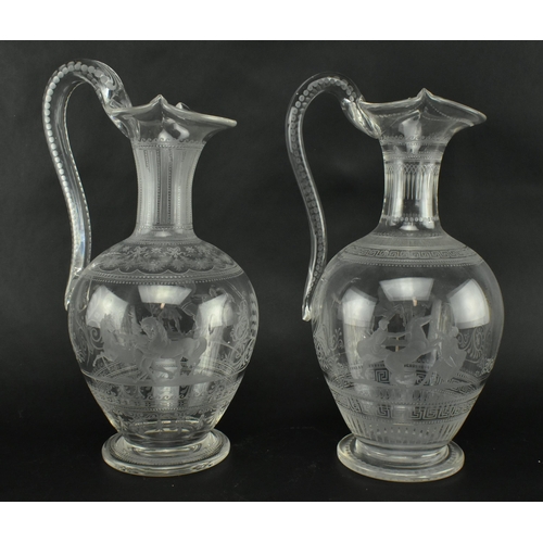 30 - A pair of mid 19th century Victorian Stourbridge style engraved claret glass ewers. Each ewer engrav... 