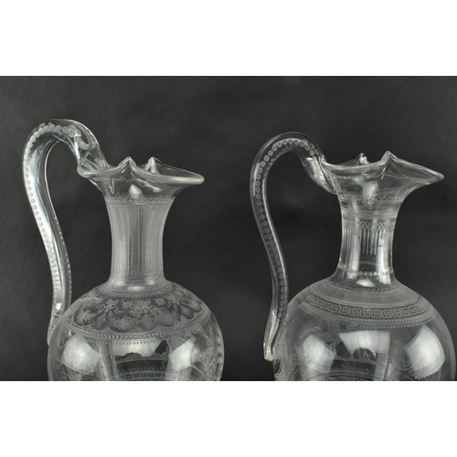 30 - A pair of mid 19th century Victorian Stourbridge style engraved claret glass ewers. Each ewer engrav... 