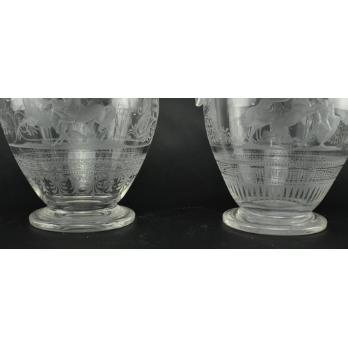 30 - A pair of mid 19th century Victorian Stourbridge style engraved claret glass ewers. Each ewer engrav... 