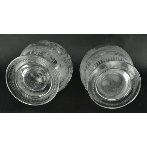 30 - A pair of mid 19th century Victorian Stourbridge style engraved claret glass ewers. Each ewer engrav... 