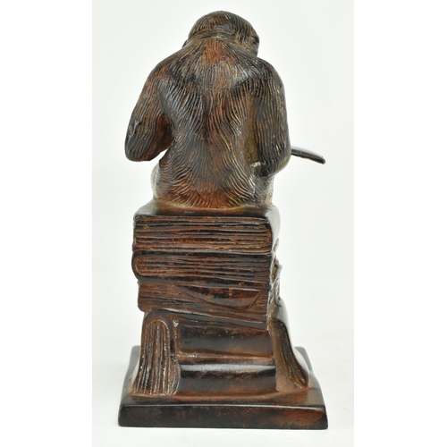 52 - A bronze figure depicting Darwin's reading monkey. The sculpture featuring a monkey reading a book i... 