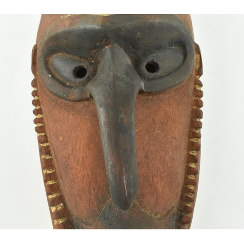 57 - A Sepik River Madang Province Papua New Guinea hand carved wooden mask. The mask featuring hooked bl... 