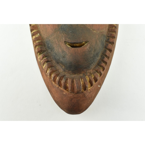 57 - A Sepik River Madang Province Papua New Guinea hand carved wooden mask. The mask featuring hooked bl... 