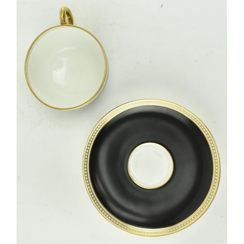 67 - A Royal Worcester for Waring & Gillow London fine bone china cup and saucer. The cup in black with g... 