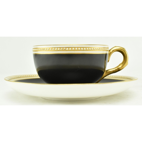 67 - A Royal Worcester for Waring & Gillow London fine bone china cup and saucer. The cup in black with g... 