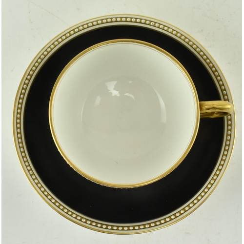 67 - A Royal Worcester for Waring & Gillow London fine bone china cup and saucer. The cup in black with g... 