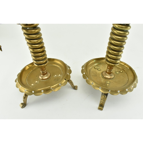 77 - A pair of German continental 19th century brass spiral chamber candle holders. Each candle holder ha... 