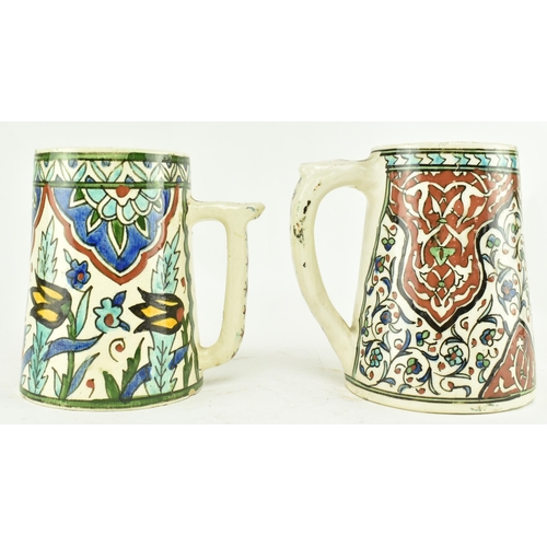 82 - A near matched pair of believed 19th century Turkish Iznik pottery hand painted ceramic mugs / cups.... 