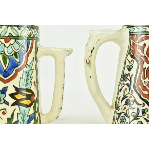 82 - A near matched pair of believed 19th century Turkish Iznik pottery hand painted ceramic mugs / cups.... 