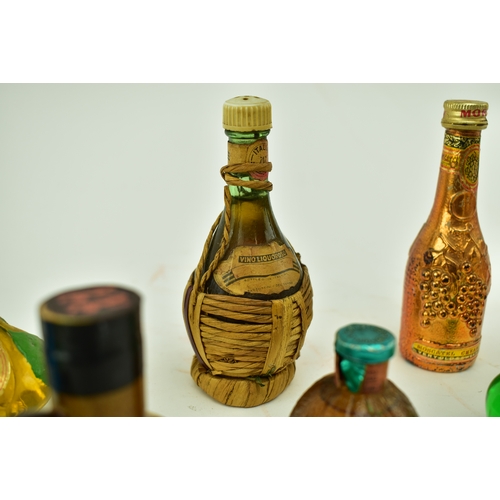 241 - A large collection of miniature bottles of brandy, cognac, whisky, gin, rum and other spirits and li... 