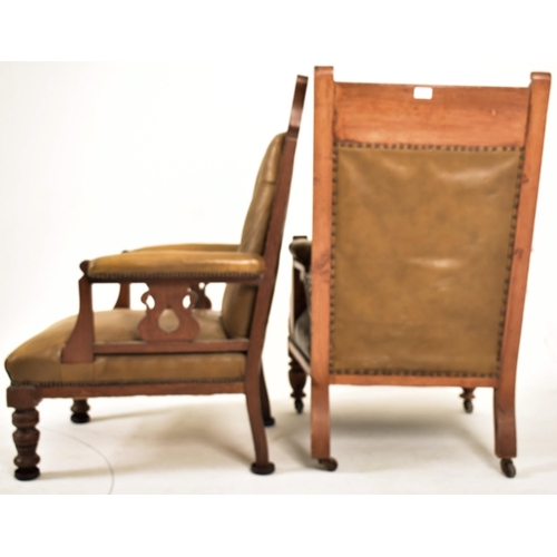 277 - A near matched pair of late Victorian carved oak & leather gentleman's library armchairs. The lot co... 