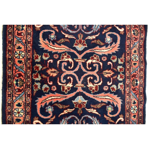 289 - A 20th century 1950s Lilihan Persian floor carpet rug runner. The runner having a cobalt blue ground... 