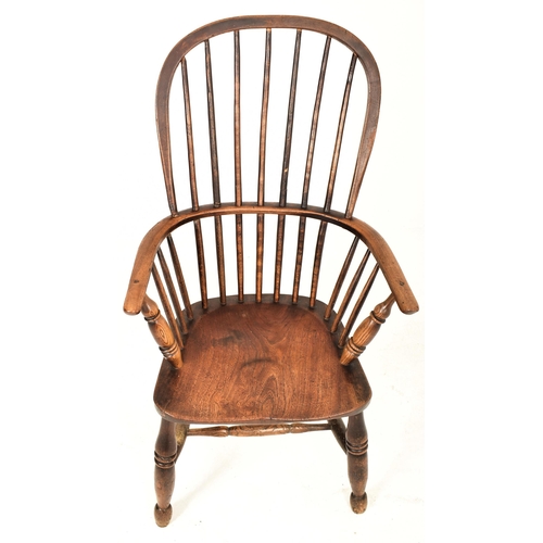 291 - A Victorian 19th century beech & elm comb back Windsor armchair. The elbow chair having a high spind... 