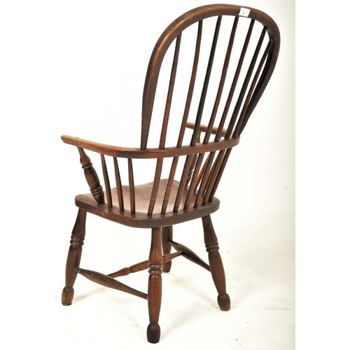 291 - A Victorian 19th century beech & elm comb back Windsor armchair. The elbow chair having a high spind... 