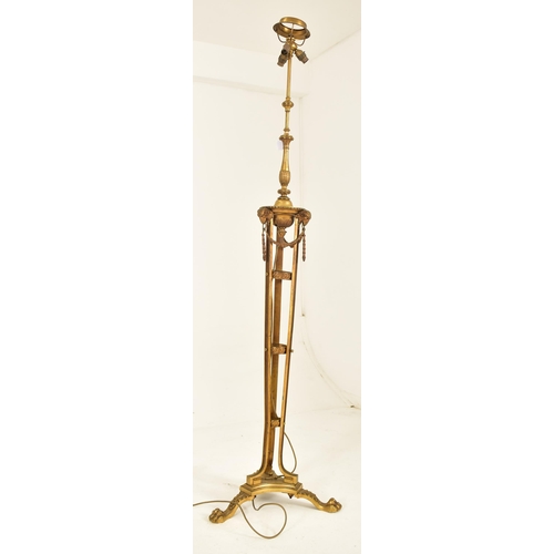 307 - A Neo-classical inspired brassed metal floor standard lamp. The lamp having three adjustable heads o... 