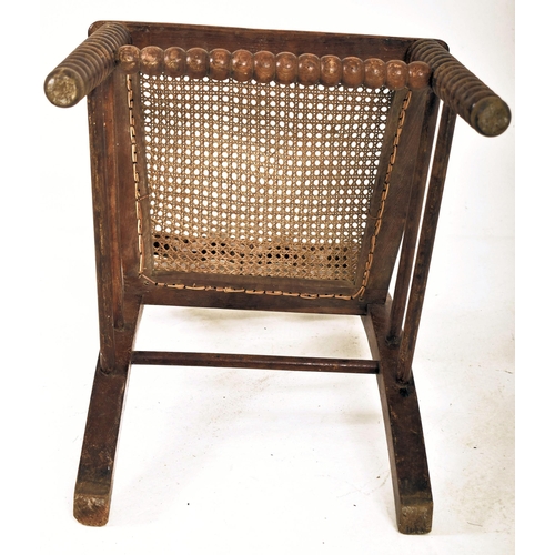 312 - An Arts & Crafts late 19th century Gothic inspired carved oak bobbin turned chair. The chair having ... 